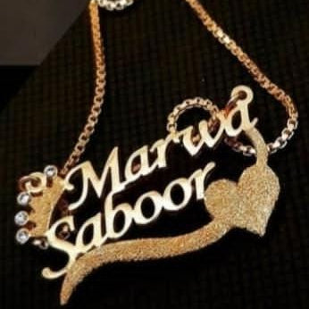 Gold necklace with 'Marwa Saboor' on a black background