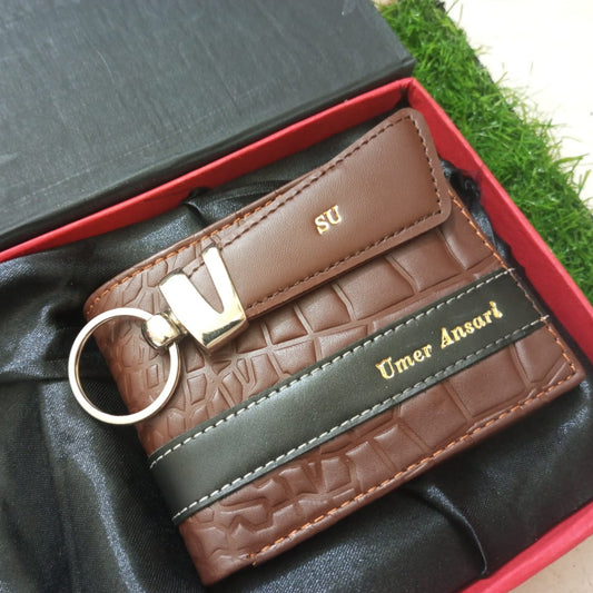 Brown leather keychain with 'UMA' branding on a black box